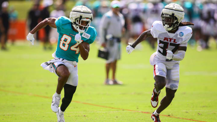 Aug 6, 2024; Miami Gardens, FL, USA; Miami Dolphins wide receiver Anthony Schwartz (84) runs against Atlanta Falcons cornerback Harrison Hand (37) during a joint practice at Baptist Health Training Complex. Mandatory Credit: Sam Navarro-USA TODAY Sports