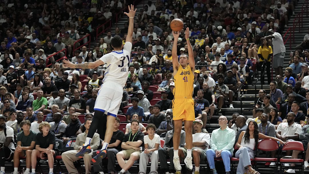 Jul 10, 2025; Las Vegas, NV, USA; Los Angeles Lakers forward Cole Swider (41) shoots a three point basket  against Dallas Mavericks forward Jordan Hall (37) in the fourth quarter of their game at Thomas & Mack Center. Mandatory Credit: Candice Ward-Imagn Images