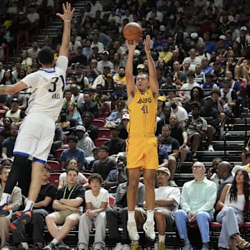 Jul 10, 2025; Las Vegas, NV, USA; Los Angeles Lakers forward Cole Swider (41) shoots a three point basket  against Dallas Mavericks forward Jordan Hall (37) in the fourth quarter of their game at Thomas & Mack Center. Mandatory Credit: Candice Ward-Imagn Images