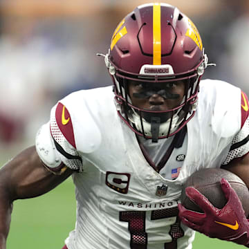 Dec 17, 2023; Inglewood, California, USA; Washington Commanders wide receiver Terry McLaurin (17) carries the ball against the Los Angeles Rams in the second half at SoFi Stadium. Mandatory Credit: Kirby Lee-Imagn Images