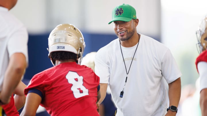 Notre Dame head coach Marcus Freeman, right, greets quarterback Kenny Minchey (8) during a Notre Dame football practice at Irish Athletic Center on Wednesday, July 31, 2024, in South Bend.