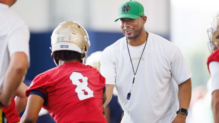 Notre Dame head coach Marcus Freeman, right, greets quarterback Kenny Minchey (8) during a Notre Dame football practice at Irish Athletic Center on Wednesday, July 31, 2024, in South Bend.