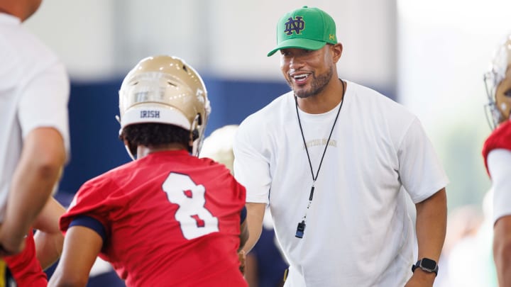 Notre Dame head coach Marcus Freeman, right, greets quarterback Kenny Minchey (8) during a Notre Dame football practice at Irish Athletic Center on Wednesday, July 31, 2024, in South Bend.