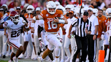 Oct 11, 2025; Dallas, Texas, USA; Texas Longhorns quarterback Arch Manning (16) runs for a first down against the Oklahoma Sooners during the second half at the Cotton Bowl.