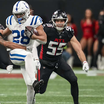 Dec 24, 2023; Atlanta, Georgia, USA; Indianapolis Colts running back Jonathan Taylor (28) runs against Atlanta Falcons cornerback A.J. Terrell (24) during the first half at Mercedes-Benz Stadium. Mandatory Credit: Dale Zanine-Imagn Images