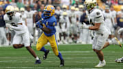 Nov 15, 2025; Pittsburgh, Pennsylvania, USA;  Pittsburgh Panthers running back Desmond Reid (0) runs the ball as Notre Dame Fighting Irish cornerback Christian Gray (6) and linebacker Drayk Bowen (34) chase during the third quarter at Acrisure Stadium. Mandatory Credit: Charles LeClaire-Imagn Images