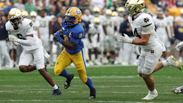 Nov 15, 2025; Pittsburgh, Pennsylvania, USA;  Pittsburgh Panthers running back Desmond Reid (0) runs the ball as Notre Dame Fighting Irish cornerback Christian Gray (6) and linebacker Drayk Bowen (34) chase during the third quarter at Acrisure Stadium. Mandatory Credit: Charles LeClaire-Imagn Images