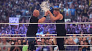Stone Cold Steve Austin and Pat McAfee toast beer during WrestleMania at AT&T Stadium. 