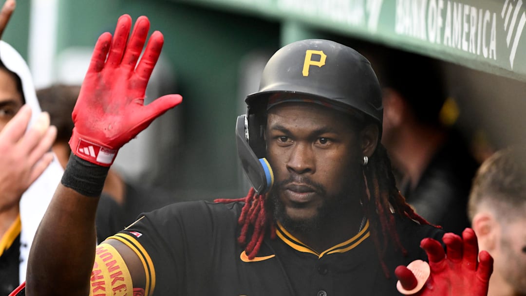 Aug 30, 2025; Boston, Massachusetts, USA; Pittsburgh Pirates center fielder Oneil Cruz (15) high-fives his teammates after hitting a solo home run against the Boston Red Sox during the fifth inning at Fenway Park. Mandatory Credit: Brian Fluharty-Imagn Images