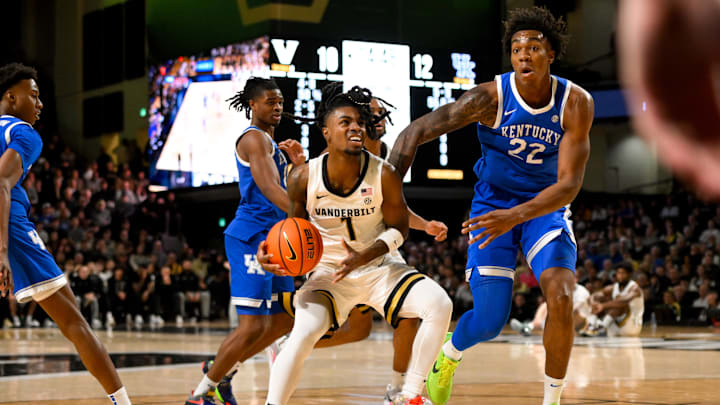 Jan 25, 2025; Nashville, Tennessee, USA;  Vanderbilt Commodores guard Jason Edwards (1) dribbles the ball against Kentucky Wildcats center Amari Williams (22) during the first half at Memorial Gymnasium. Mandatory Credit: Steve Roberts-Imagn Images