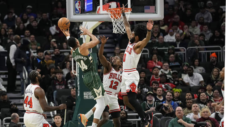 Milwaukee Bucks forward Giannis Antetokounmpo (34) shoots against Chicago Bulls guards Ayo Dosunmu (12) and Coby White (0) during the first quarter at Fiserv Forum. 