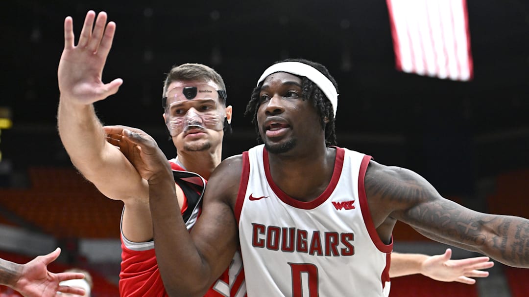 Oct 25, 2025; Pullman, WA, USA; Washington State Cougars forward Emmanuel Ugbo (0) fights for position against New Mexico Lobos forward Milos Vicentic (31) in the second half at Friel Court at Beasley Coliseum. Washington State Cougars won 74-66. Mandatory Credit: James Snook-Imagn Images