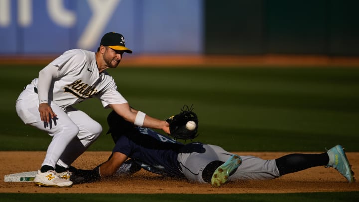 Seattle Mariners outfielder Julio Rodríguez (bottom) steals second base during a game against the Oakland Athletics on Monday at Oakland Coliseum.