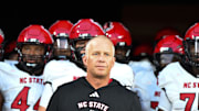 Sep 11, 2025; Winston-Salem, North Carolina, USA;  North Carolina State Wolfpack head coach Dave Doeren walks his team out on the field against the Wake Forest Demon Deacons at Allegacy Federal Credit Union Stadium. Mandatory Credit: Luke Jamroz-Imagn Images