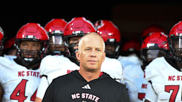 Sep 11, 2025; Winston-Salem, North Carolina, USA;  North Carolina State Wolfpack head coach Dave Doeren walks his team out on the field against the Wake Forest Demon Deacons at Allegacy Federal Credit Union Stadium. Mandatory Credit: Luke Jamroz-Imagn Images