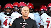 Sep 11, 2025; Winston-Salem, North Carolina, USA;  North Carolina State Wolfpack head coach Dave Doeren walks his team out on the field against the Wake Forest Demon Deacons at Allegacy Federal Credit Union Stadium. Mandatory Credit: Luke Jamroz-Imagn Images
