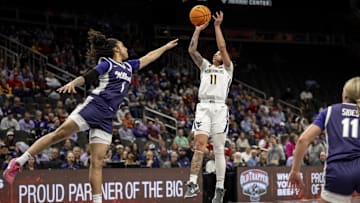 Mar 7, 2025; Kansas City, MO, USA; West Virginia Mountaineers JJ Quinerly (11) shoots the ball while defended by Kansas State Wildcats guard Zyanna Walker (1) in the first quarter at T-Mobile Center. Mandatory Credit: Amy Kontras-Imagn Images