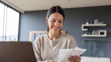 Happy woman working at home and smiling