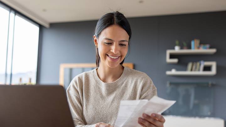 Happy woman working at home and smiling