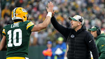 Green Bay Packers quarterback Jordan Love (10) high fives head coach Matt LaFleur after throwing a touchdown pass during the second quarter of their game against the Chicago Bear Sunday, January 7, 2024 at Lambeau Field in Green Bay, Wisconsin.