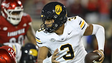 Nov 8, 2025; Louisville, Kentucky, USA;  California Golden Bears quarterback Jaron-Keawe Sagapolutele (3) runs the ball against Louisville Cardinals defensive back D'Angelo Hutchinson (21) during the second half at L&N Federal Credit Union Stadium. California defeated Louisville 29-26. Mandatory Credit: Jamie Rhodes-Imagn Images