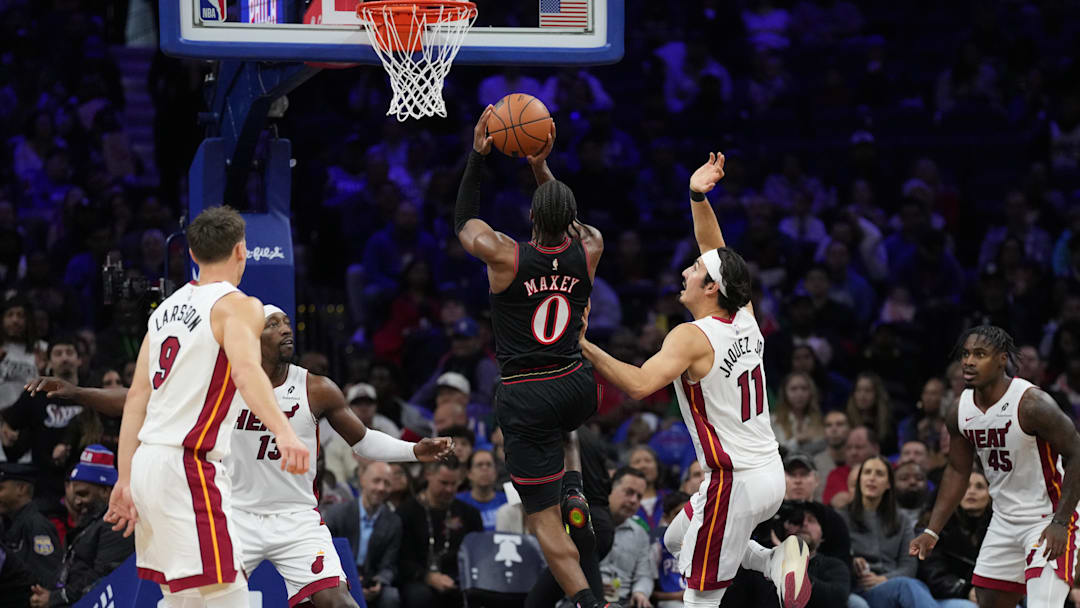 Nov 23, 2025; Philadelphia, Pennsylvania, USA; Philadelphia 76ers guard Tyrese Maxey (0) drives to shoot against Miami Heat forward Jaime Jaquez Jr. (11)  in the first quarter at Xfinity Mobile Arena. Mandatory Credit: Kyle Ross-Imagn Images