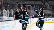 Apr 3, 2025; San Jose, California, USA; San Jose Sharks center Macklin Celebrini (71) and center Will Smith (2) throw pucks into the crowd during warm ups before their game against the Edmonton Oilers at SAP Center at San Jose. Mandatory Credit: Eakin Howard-Imagn Images