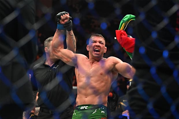 Dricus Du Plessis (blue gloves) celebrates defeating Sean Strickland (red glove) during UFC 297 at ScotiaBank Arena. 