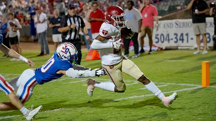 Oct 27, 2023; Metairie, LA, USA; Brother Martin Crusaders wide receiver Easton Royal (23) scores a touchdown against John Curtis Patriots linebacker Benjamin Barron (30) during the first quarter at The Shrine on Airline. Mandatory Credit: Matthew Hinton-USA TODAY Sports