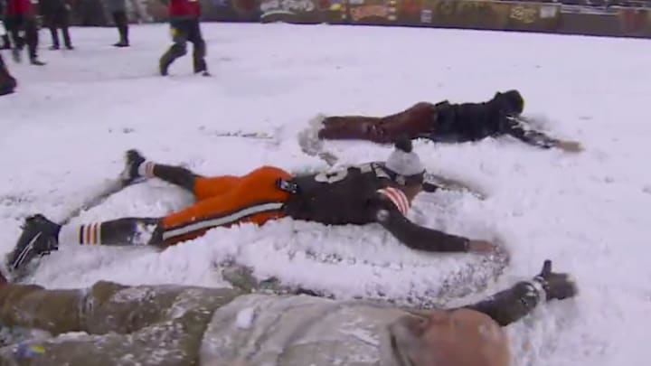 Cleveland Browns quarterback Jameis Winston making snow angels on Huntington Bank Field alongside Thursday Night Football analysts Ryan Fitzpatrick and Andrew Whitworth on November 21, 2024. 