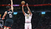 Nov 21, 2025; Houston, Texas, USA; Denver Nuggets forward Cameron Johnson (23) shoots the ball as Houston Rockets guard Reed Sheppard (15) defends during the fourth quarter at Toyota Center. Mandatory Credit: Troy Taormina-Imagn Images
