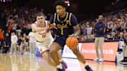 Jan 25, 2025; Charlottesville, Virginia, USA; Notre Dame Fighting Irish guard Julian Roper II (1) controls the ball as Virginia Cavaliers guard Isaac McKneely (11) defends during the first half at John Paul Jones Arena. 