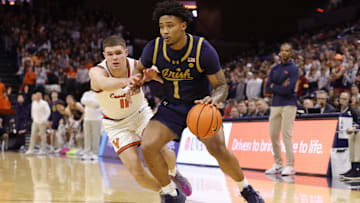 Jan 25, 2025; Charlottesville, Virginia, USA; Notre Dame Fighting Irish guard Julian Roper II (1) controls the ball as Virginia Cavaliers guard Isaac McKneely (11) defends during the first half at John Paul Jones Arena. 