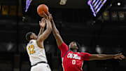 Jan 25, 2025; Columbia, Missouri, USA; Missouri Tigers guard Tony Perkins (12) shoots against Mississippi Rebels forward Malik Dia (0) during the first half at Mizzou Arena. Mandatory Credit: Jay Biggerstaff-Imagn Images