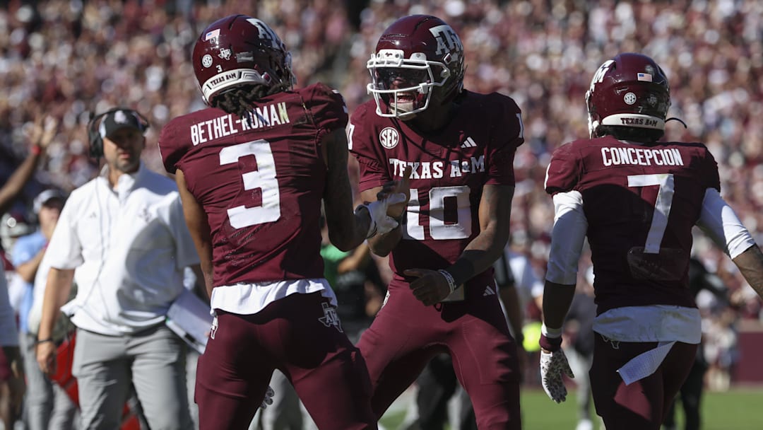Nov 15, 2025; College Station, Texas, USA; Texas A&M Aggies quarterback Marcel Reed (10) celebrates with wide receiver Ashton Bethel-Roman (3) after a touchdown during the third quarter against the South Carolina Gamecocks at Kyle Field. Mandatory Credit: Troy Taormina-Imagn Images
