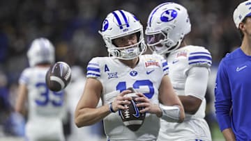 Brigham Young Cougars quarterback Jake Retzlaff warms up before a college football game against the Colorado Buffaloes 