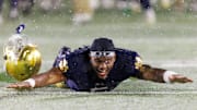 Notre Dame wide receiver Cam Williams slides in the snow after winning a NCAA football game 49-10 against Navy at Notre Dame Stadium on Saturday, Nov. 8, 2025, in South Bend.