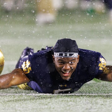 Notre Dame wide receiver Cam Williams slides in the snow after winning a NCAA football game 49-10 against Navy at Notre Dame Stadium on Saturday, Nov. 8, 2025, in South Bend.