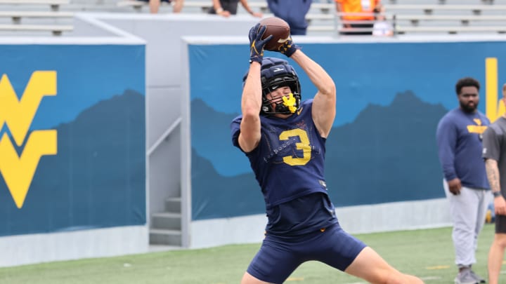 West Virignia University receiver Hudson Clement snags a pass in the endzone during drills at fall camp. 