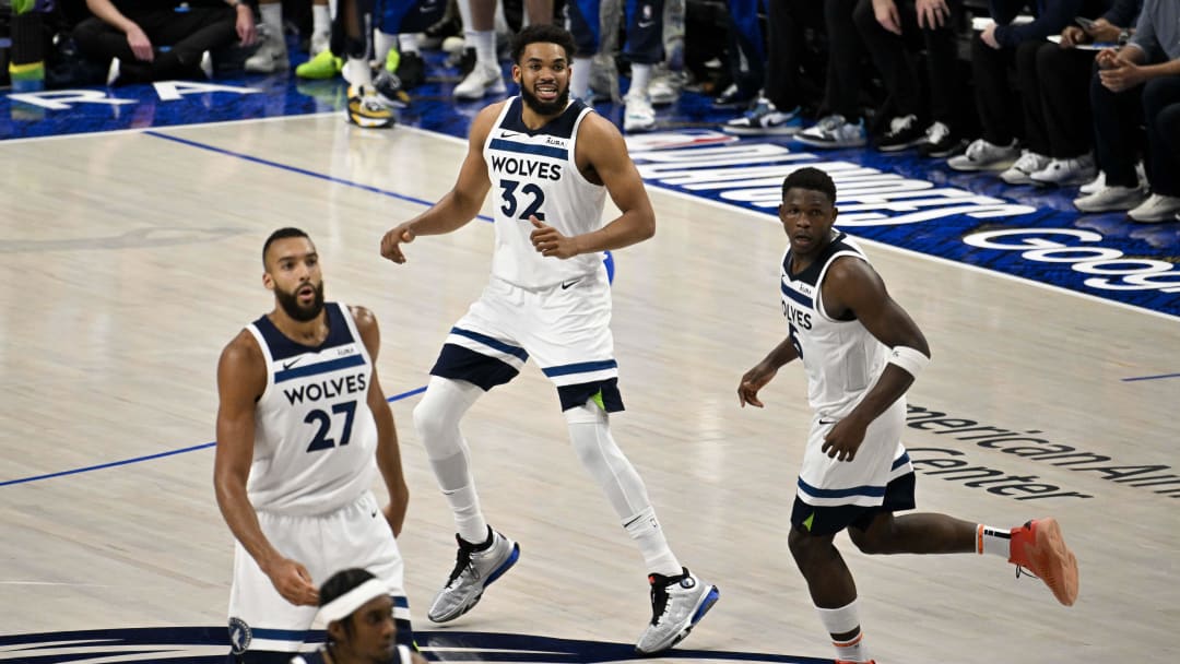 May 28, 2024; Dallas, Texas, USA; Minnesota Timberwolves center Rudy Gobert (27) and center Karl-Anthony Towns (32) and guard Anthony Edwards (5) celebrate during the second half against the Dallas Mavericks in game four of the western conference finals for the 2024 NBA playoffs at American Airlines Center.