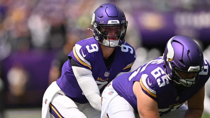 Vikings quarterback J.J. McCarthy and center Michael Jurgens warm up before the game against the Las Vegas Raiders at U.S. Bank Stadium.