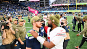 Nov 9, 2025; Seattle, Washington, USA; Seattle Seahawks quarterback Sam Darnold (14) greets Arizona Cardinals quarterback Jacoby Brissett (7) on the field after the game at Lumen Field. Mandatory Credit: Steven Bisig-Imagn Images
