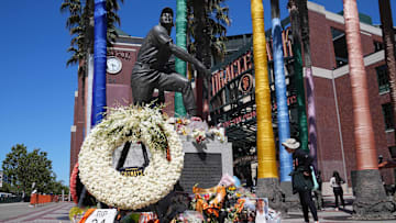 Jun 26, 2024; San Francisco, California, USA; Flowers are laid at the statue of San Francisco Giants former center fielder Willie Mays before the game against the Chicago Cubs at Oracle Park. Mandatory Credit: Darren Yamashita-Imagn Images