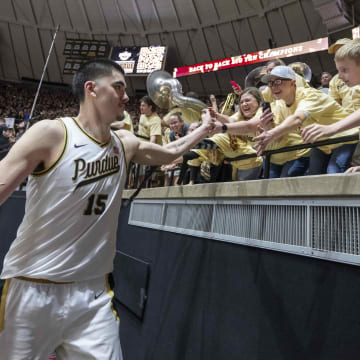 Purdue Boilermakers center Zach Edey high fives the student section 