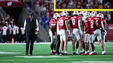 Oct 11, 2025; Madison, Wisconsin, USA; Wisconsin Badgers head coach Luke Fickell and his team take a timeout in the second half against the Iowa Hawkeyes at Camp Randall Stadium. Mandatory Credit: Ross Harried-Imagn Images