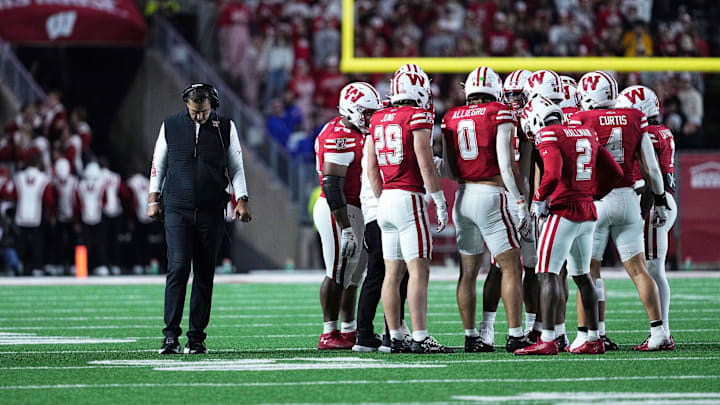 Oct 11, 2025; Madison, Wisconsin, USA; Wisconsin Badgers head coach Luke Fickell and his team take a timeout in the second half against the Iowa Hawkeyes at Camp Randall Stadium. Mandatory Credit: Ross Harried-Imagn Images