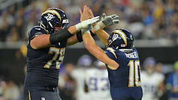 Los Angeles Chargers QB Justin Herbert (10) reacts with OT Joe Alt (76) against the Minnesota Vikings at SoFi Stadium