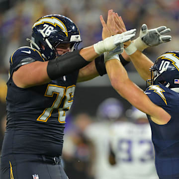 Oct 23, 2025; Inglewood, California, USA; Los Angeles Chargers quarterback Justin Herbert (10) reacts with offensive tackle Joe Alt (76) during the second half at SoFi Stadium. Mandatory Credit: Jayne Kamin-Oncea-Imagn Images