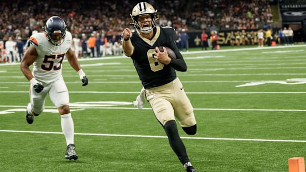 New Orleans Saints quarterback Tyler Shough (6) runs in for a touchdown against Denver Broncos linebacker Andrew Farmer (53).