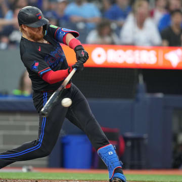 Jun 19, 2024; Toronto, Ontario, CAN; Toronto Blue Jays designated hitter Justin Turner (2) hits into a double play but scores a run against the Boston Red Sox during fourth inning at Rogers Centre. Mandatory Credit: Nick Turchiaro-USA TODAY Sports